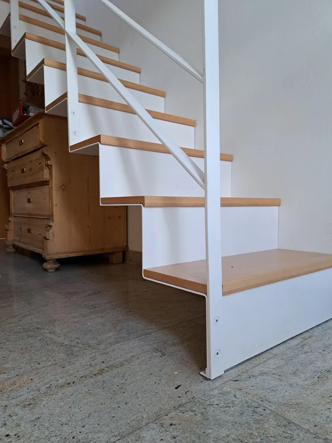 M-17: Weiße Mittelholmtreppe mit Holzstufen – Referenzprojekt
